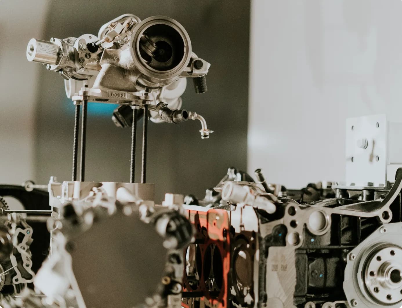 Cast automotive engine components and turbocharger assembly on display