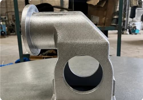 Die cast aluminum elbow housing with a machined bore