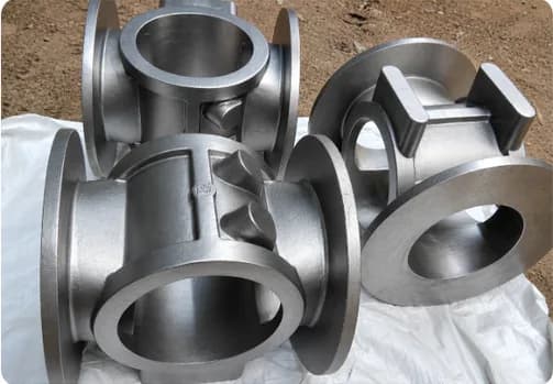Cast aluminum pipe fittings and flanges clustered together